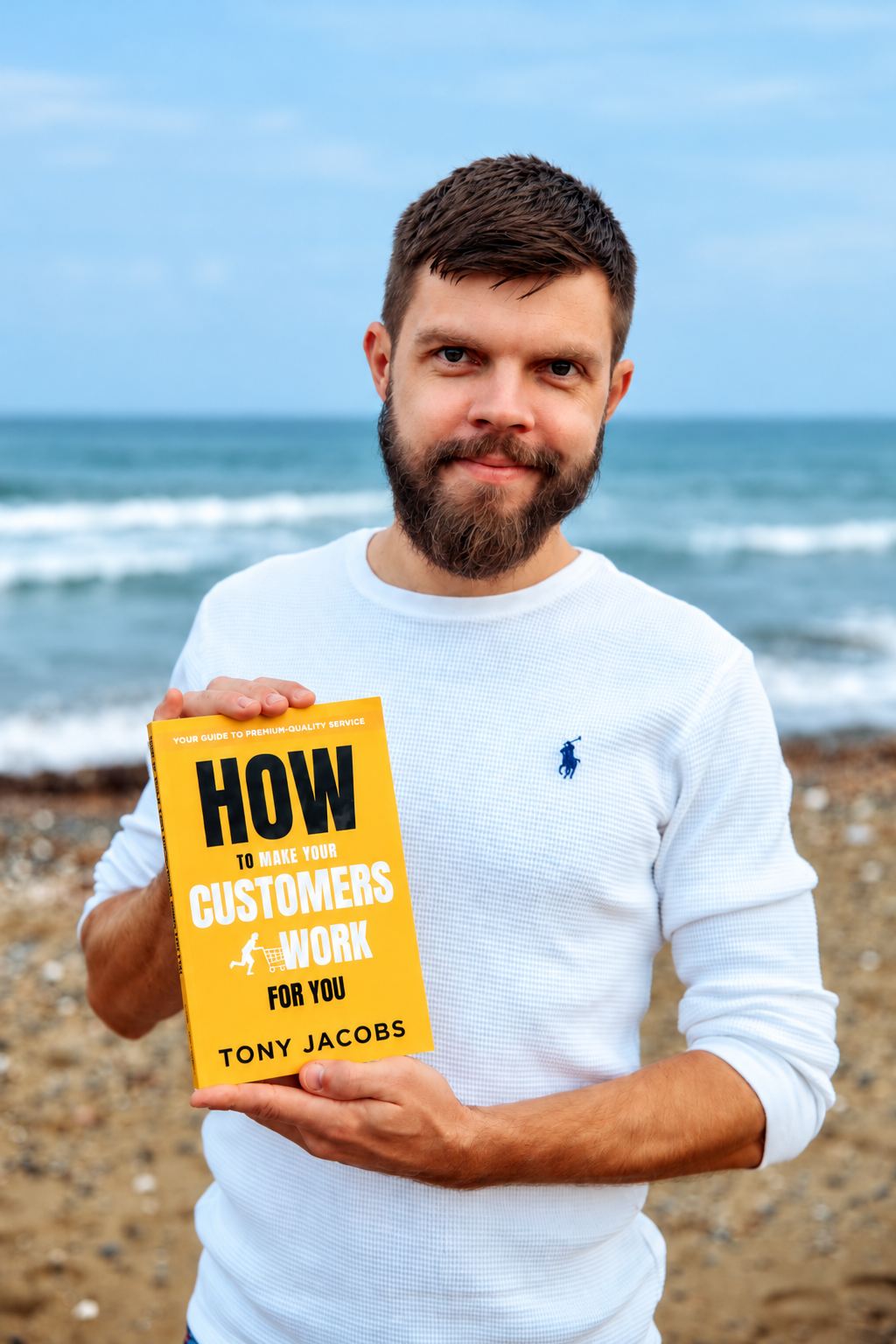 Tony Jacobs reading his yellow book on the beach